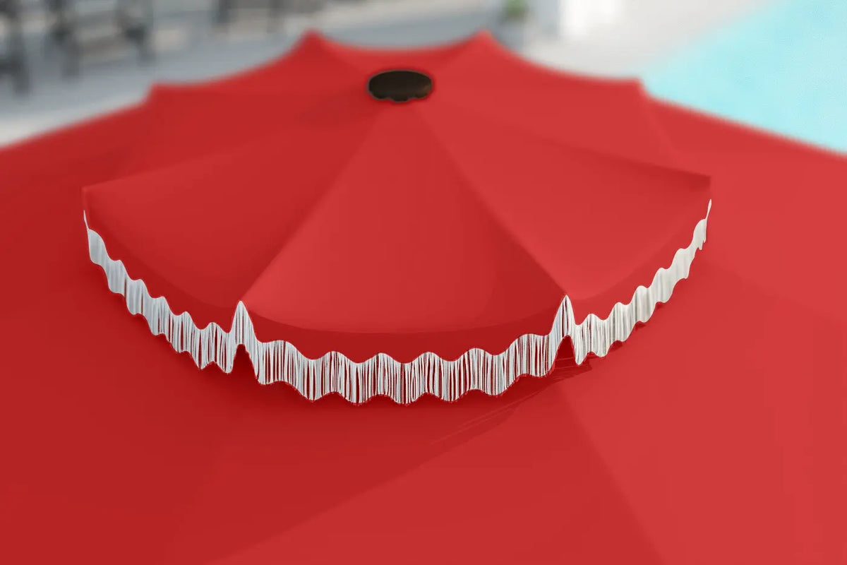 Red outdoor umbrella with white trim on a red surface