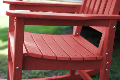 Close-up of a red wooden chair with a blurred green background