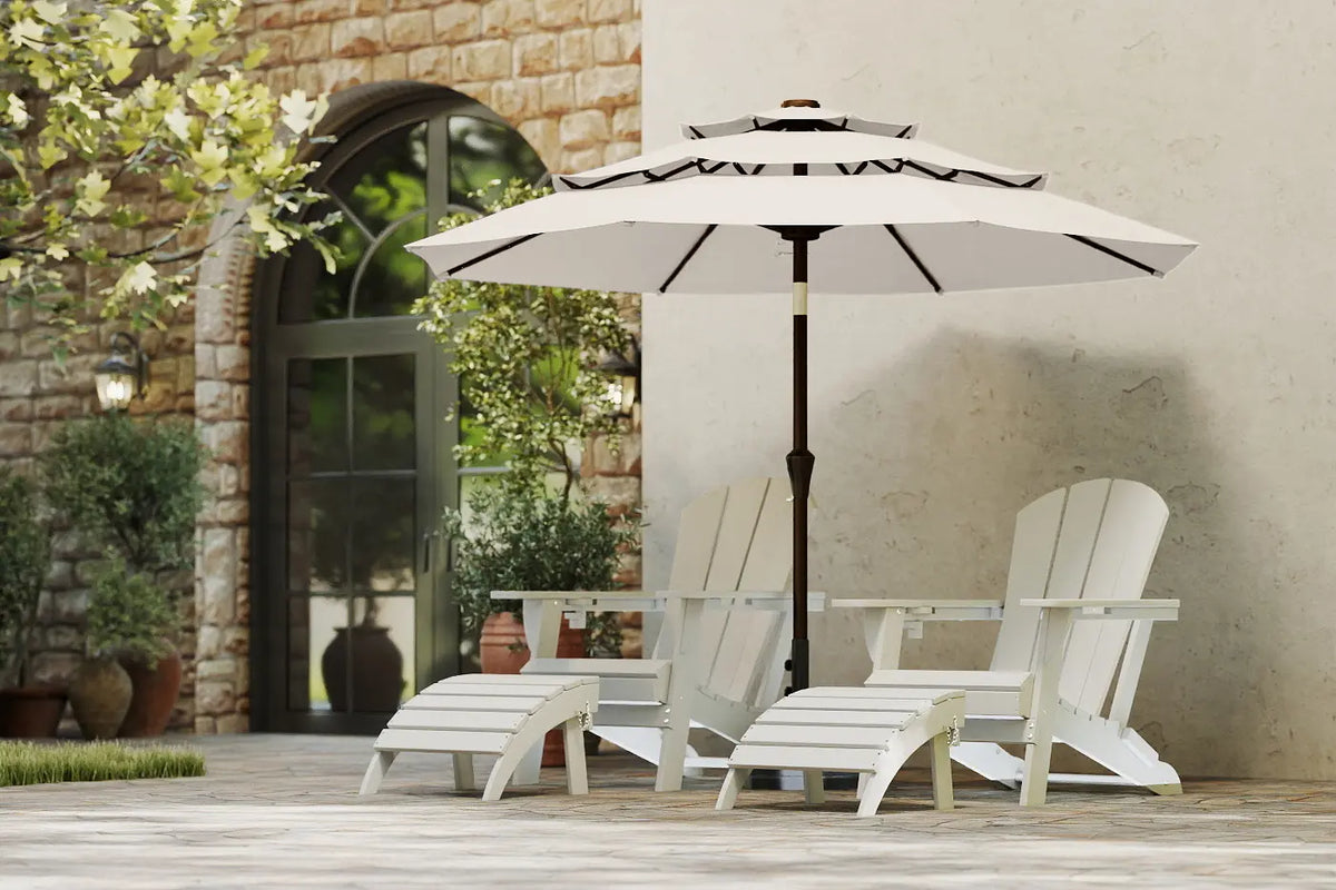 White patio chairs and table with a large umbrella on a wooden deck.