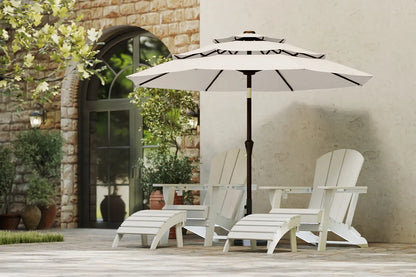 White patio chairs and table with a large umbrella on a wooden deck.