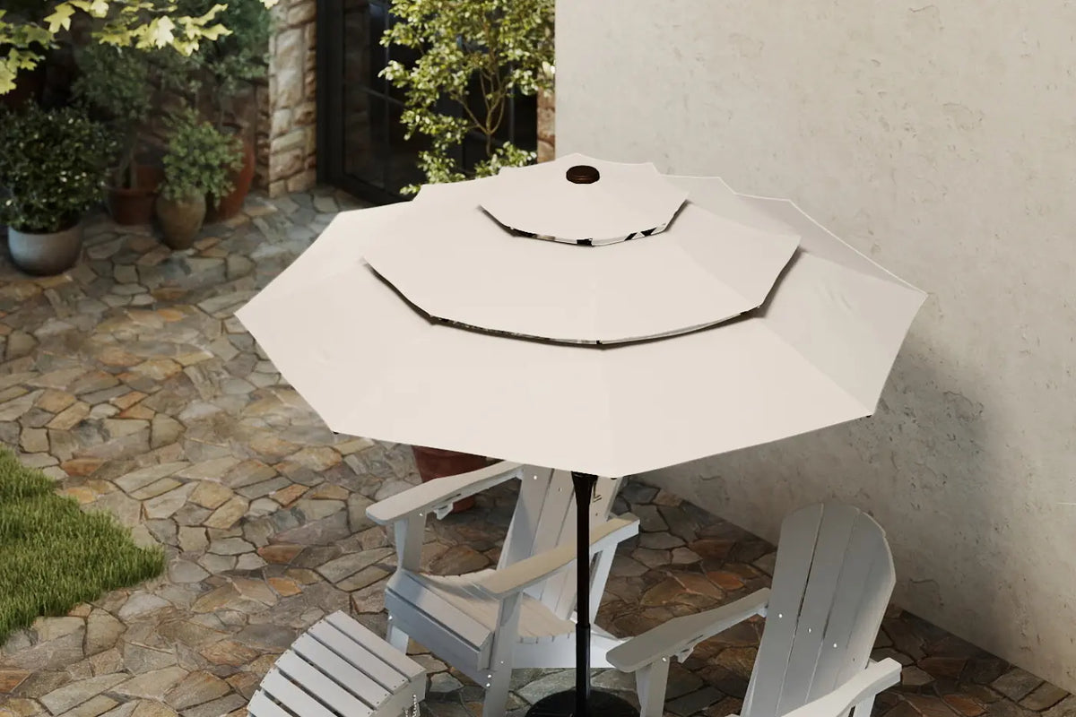 White patio umbrella on a stand with chairs underneath in an outdoor setting.
