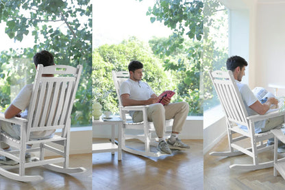 Man using a smartphone in a modern living room with a white rocking chair.