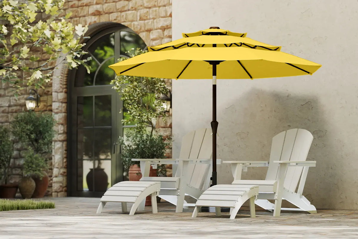 Yellow patio umbrella with white chairs on a wooden deck.