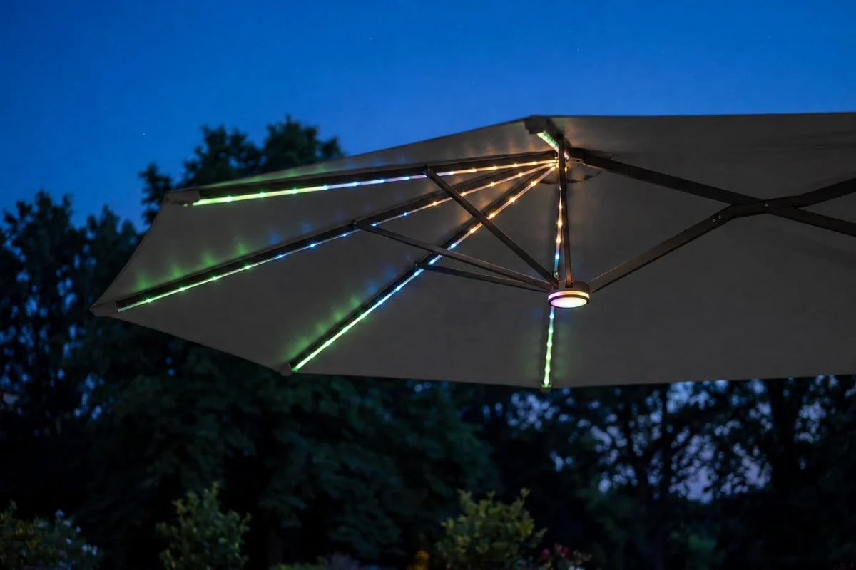 Dark gray outdoor patio umbrella with integrated RGB LED canopy lights against a twilight sky and trees.