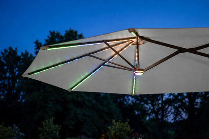 A large gray patio umbrella with integrated RGB LED string lights, shown against a twilight sky and dark trees.
