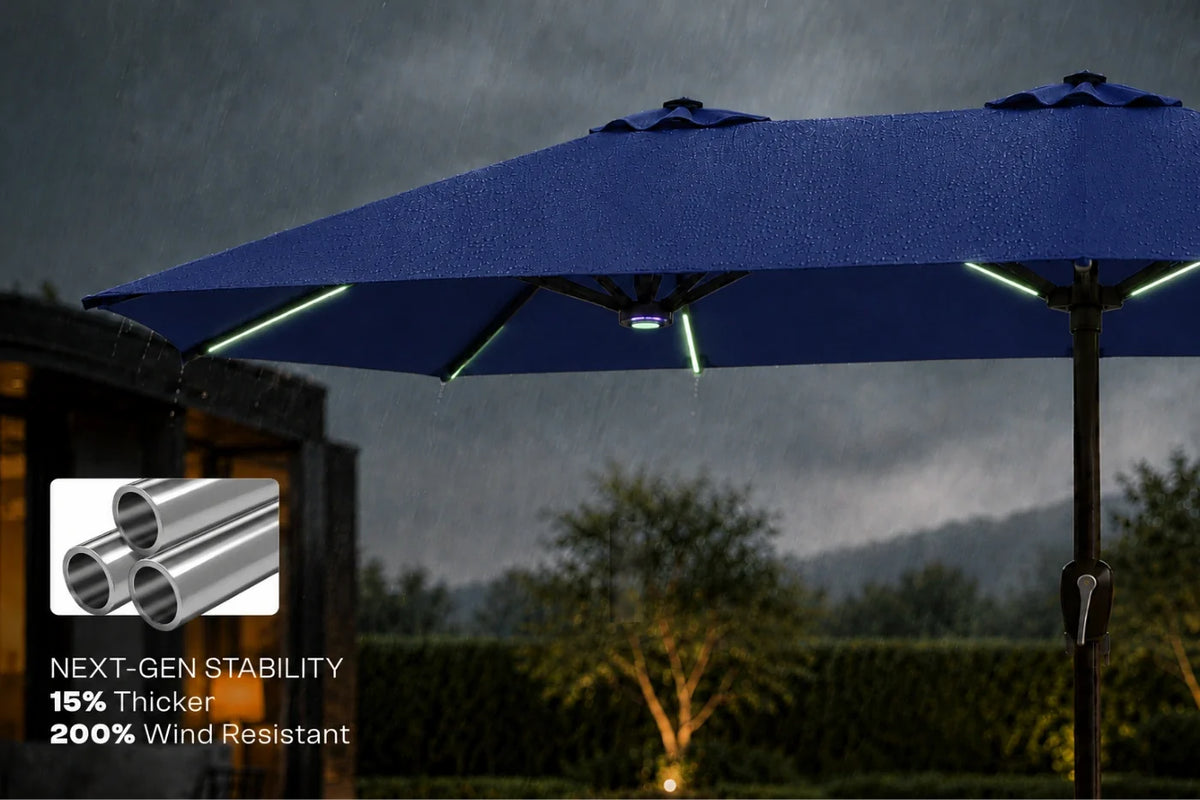 A navy blue patio umbrella shown outdoors in the rain with integrated RGB LED light strips visible along the underside. A small inset graphic in the lower left highlights sturdier metal poles with text reading 'NEXT-GEN STABILITY 15% Thicker 200% Wind Resistant.