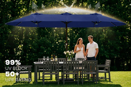 A large navy blue outdoor patio umbrella shades a dining table and chairs in a garden setting, with a couple standing underneath. Sunlight is shining through the canopy, and text on the left reads '99% UV BLOCK 50+ UPF RATING'.