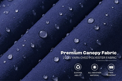 Close-up of navy blue fabric with water droplets on the surface, showing rolled folds and text that reads 'Premium Canopy Fabric' and '220G YARN-DYED POLYESTER FABRIC,' plus small icons for sustainability, all-weather material, and fade resistance.