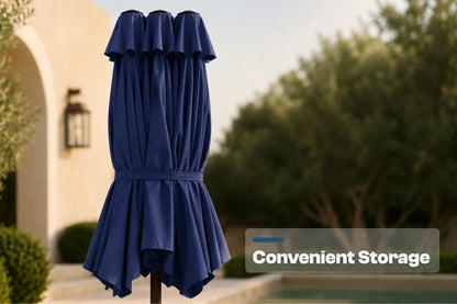 A navy blue closed patio umbrella with pleated fabric, shown outdoors in front of a house and trees. A text overlay on the right reads 'Convenient Storage'.