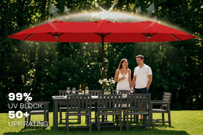 A large red patio umbrella shown on a lawn with a dining table and chairs, and a couple standing underneath. Text on the left reads '99% UV BLOCK 50+ UPF RATING'.