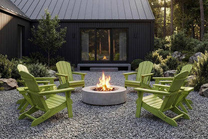 Green Adirondack chairs around a fire pit in front of a dark wooden cabin.