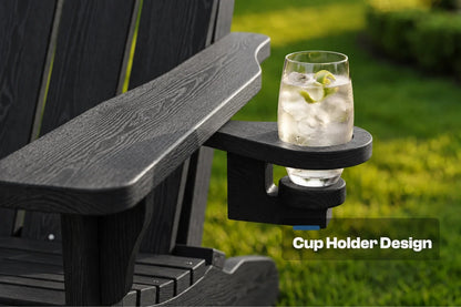 A black outdoor Adirondack-style chair arm with a mounted cup holder, shown holding a clear glass of iced drink with lime slices. The background is a blurred green lawn, and the text 'Cup Holder Design' appears in the lower right.