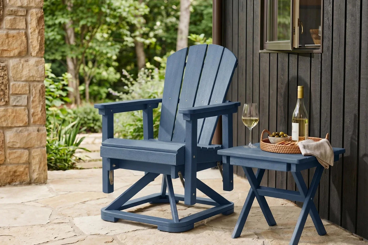 Navy blue Adirondack chair on a patio with a small table holding wine glasses and a bottle.