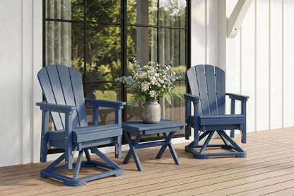 Two navy blue Adirondack chairs with a small table and flowers on a wooden deck.