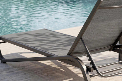 Gray lounge chair by a pool