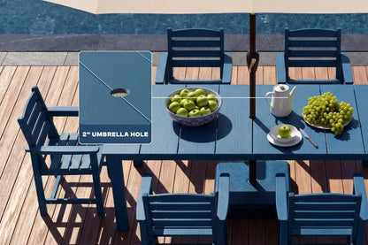 Blue outdoor table with chairs and a bowl of apples near a pool