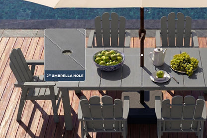 Dark gray Outdoor patio set with table, chairs, and umbrella hole on a wooden deck by a pool.