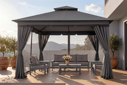 Outdoor gazebo with curtains, furniture, and a view of mountains.