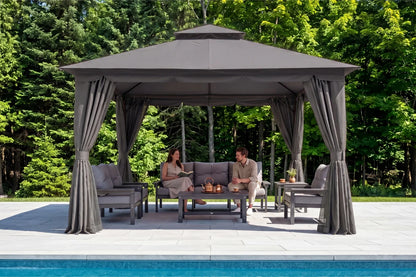 Two people sitting under a gray gazebo by a pool with trees in the background