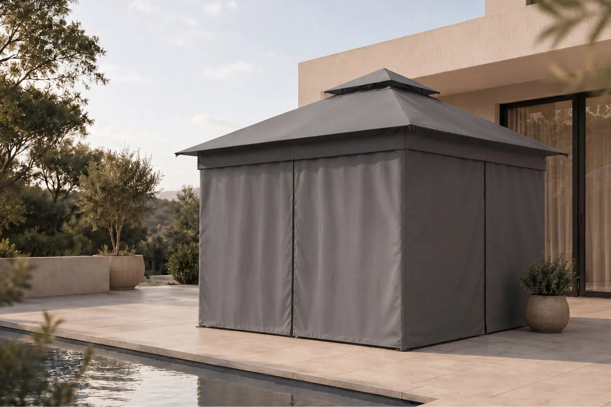 Gray outdoor gazebo with curtains on a patio near a pool