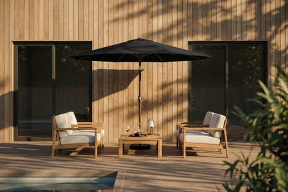 Outdoor patio set with two chairs, a table, and an umbrella against a wooden wall.