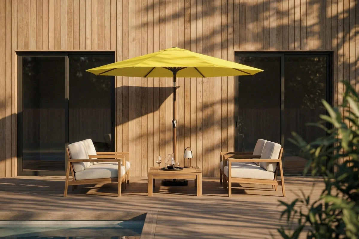 Outdoor patio set with two chairs and a table under a yellow umbrella on a wooden deck.
