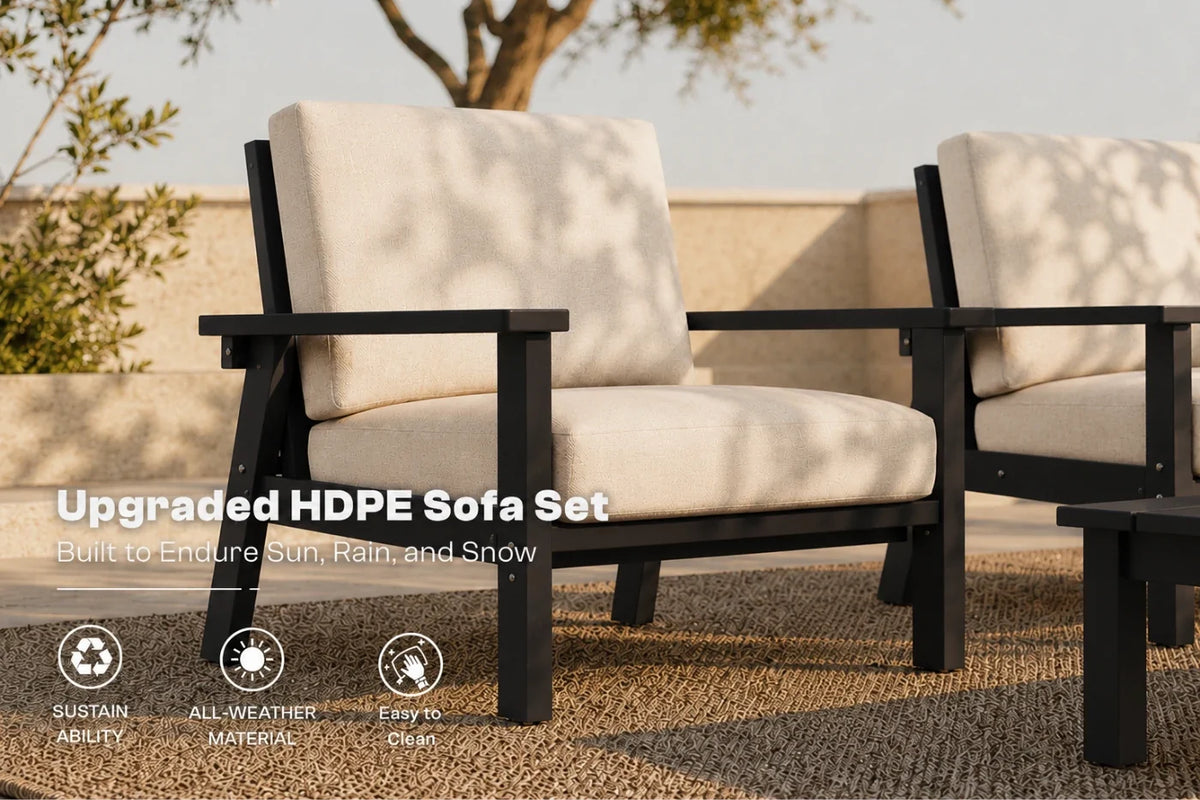 Outdoor patio furniture set featuring two black HDPE armchairs with creamy white cushions, shown on a woven rug with a stone wall and tree in the background. Text overlays highlight the 'Upgraded HDPE Sofa Set' and feature icons for sustainability, all-weather material, and easy clean.
